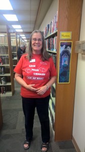 Ann Elliot stands in the mystery section of the library